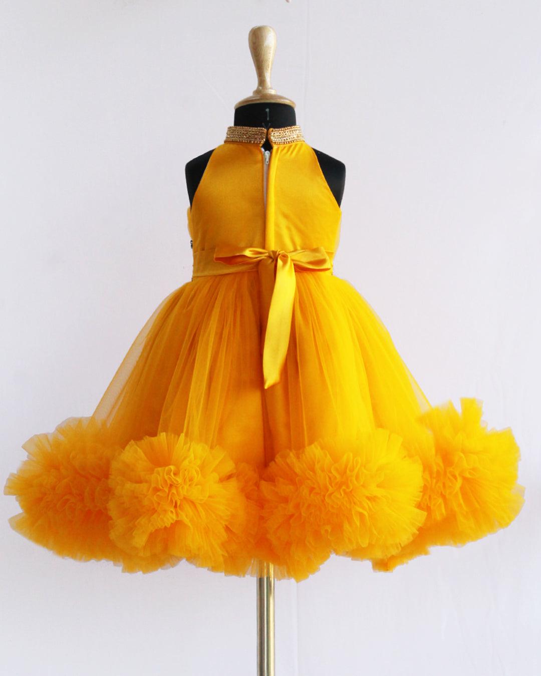 Mango Yellow Pleated Halter Neck Ruffled Frock.
Material : Mango Yellow  soft mono nylon net is mainly used for making this dress. Yoke portion is designed in a pleated pattern with halter neck design. Skirt port