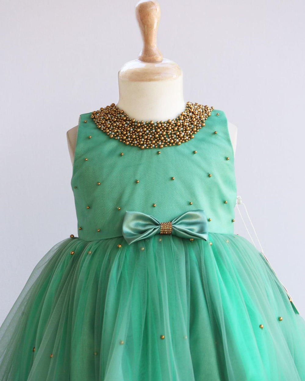 Pastel Green Beads Handwork Ruffles Frock
Material: Pastel Green Shade Frock mono net used on the frock. Yoke portion is designed with handwork pattern with neck fully designed with beads. Center portion is