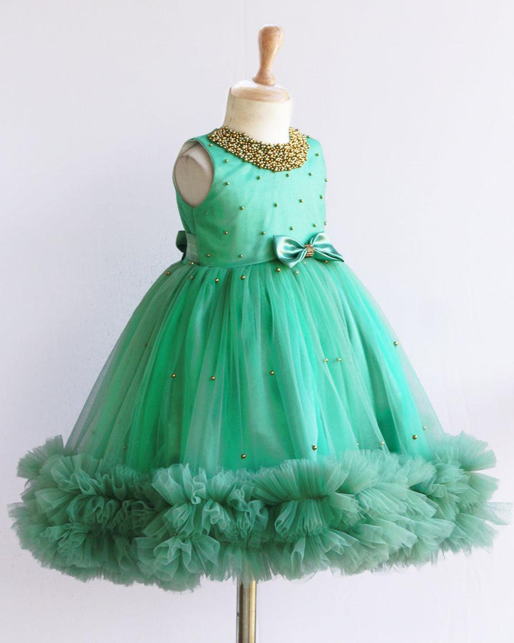 Pastel Green Beads Handwork Ruffles Frock
Material: Pastel Green Shade Frock mono net used on the frock. Yoke portion is designed with handwork pattern with neck fully designed with beads. Center portion is